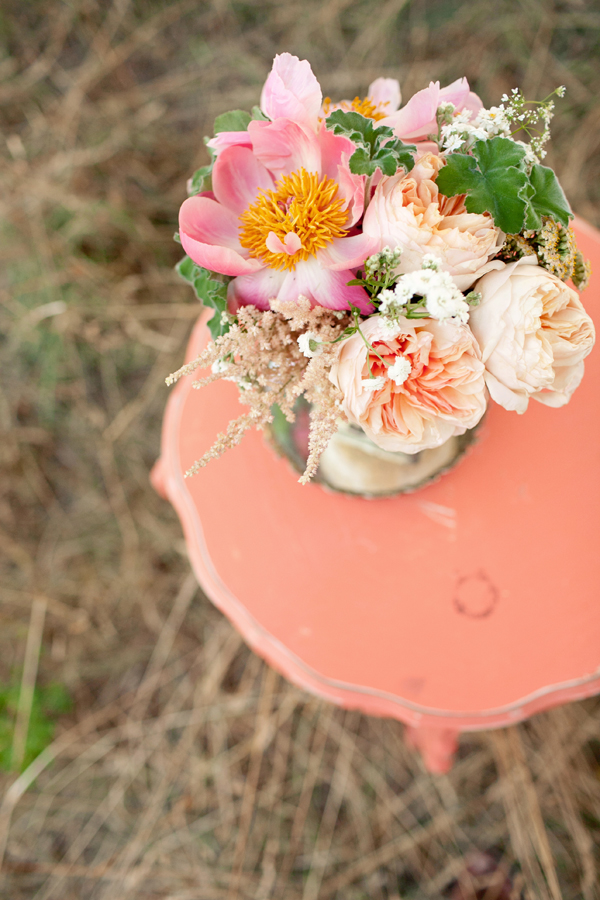 Pretty pink flower arrangement on vintage inspired coral side table - Photo by Studio 6.23
